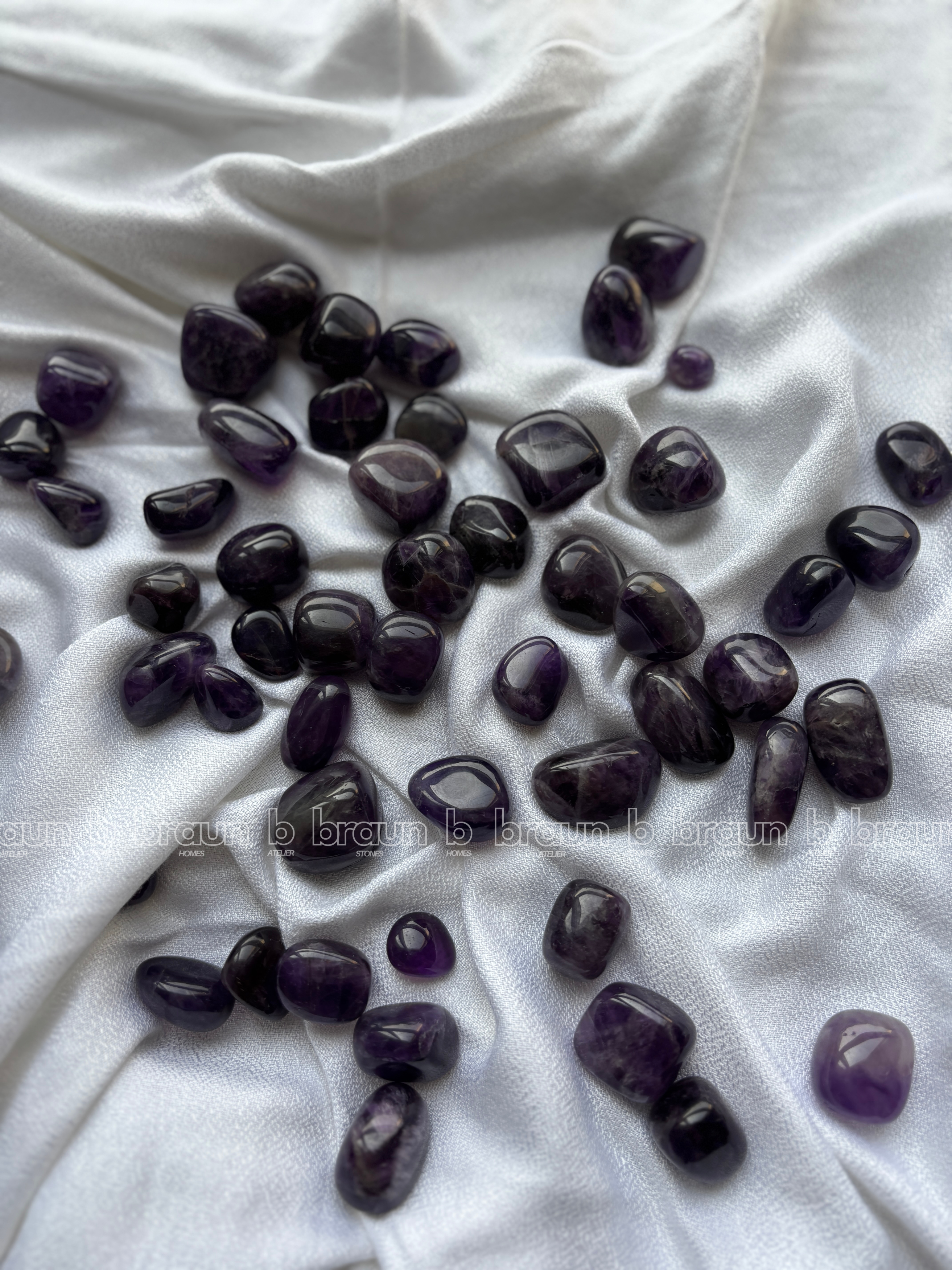 Natural amethyst tumbled crystals by Braun Homes polished healing stones for meditation, Reiki, chakra balancing, anxiety relief, and spiritual energy protection in deep purple hues