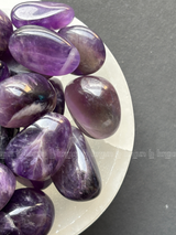Natural amethyst tumbled crystals by Braun Homes polished healing stones for meditation, Reiki, chakra balancing, anxiety relief, and spiritual energy protection in deep purple hues