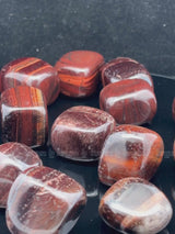 NaturalRed Tiger Eye tumbled crystals by Braun Homes √ê polished healing stones for meditation, Reiki, chakra balancing, anxiety relief, and spiritual energy protection in deep purple hues